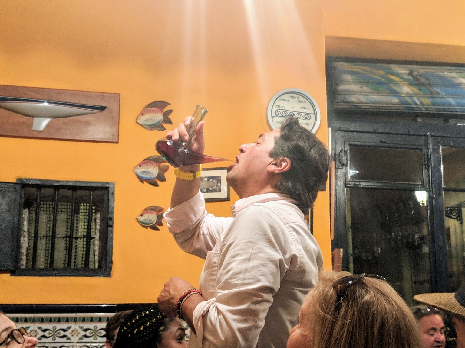 Our food tour guide demonstrating how to drink from a porron properly. It's harder than it looks!