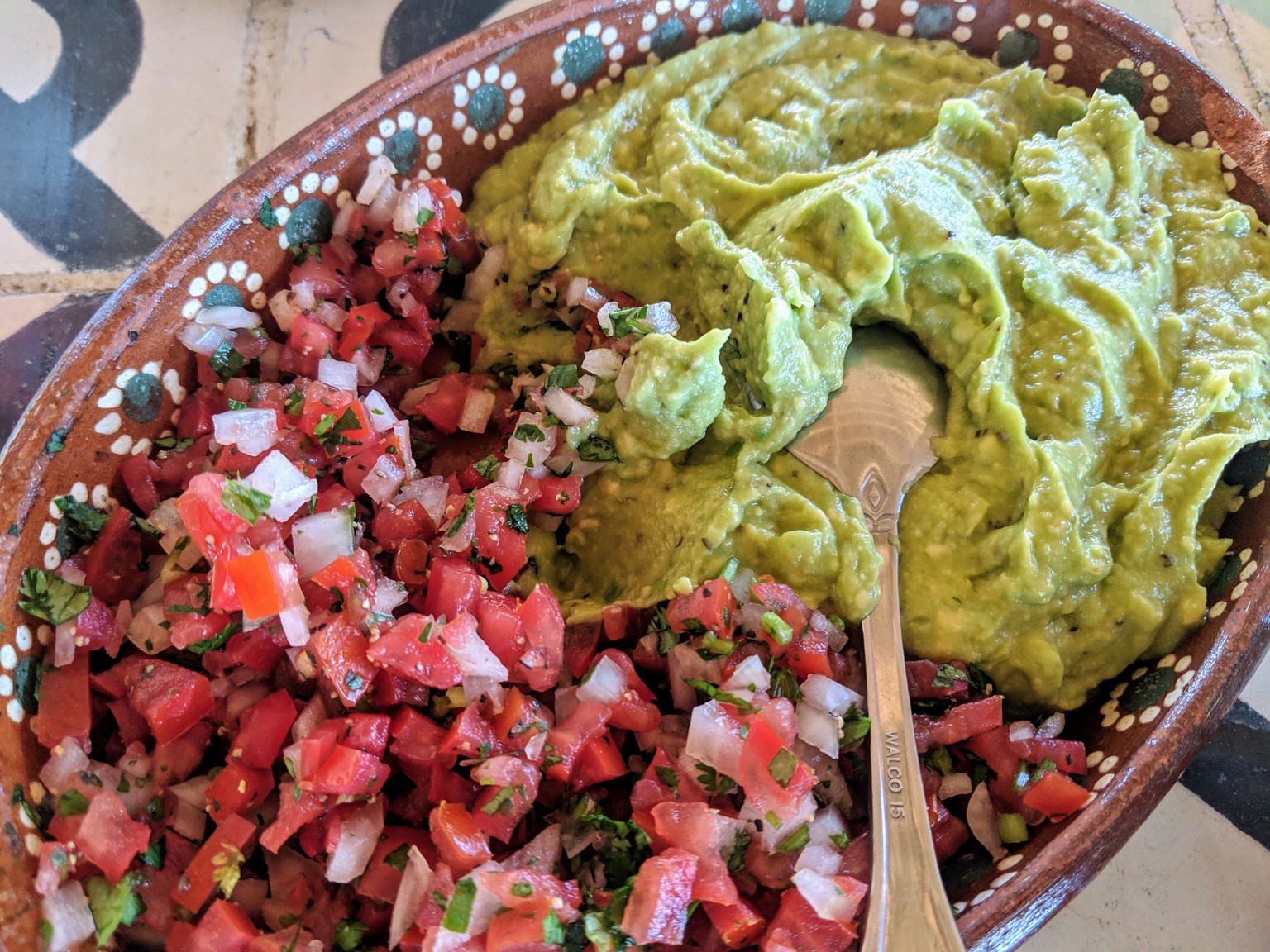 Massive amount of guacamole and pico de gallo.