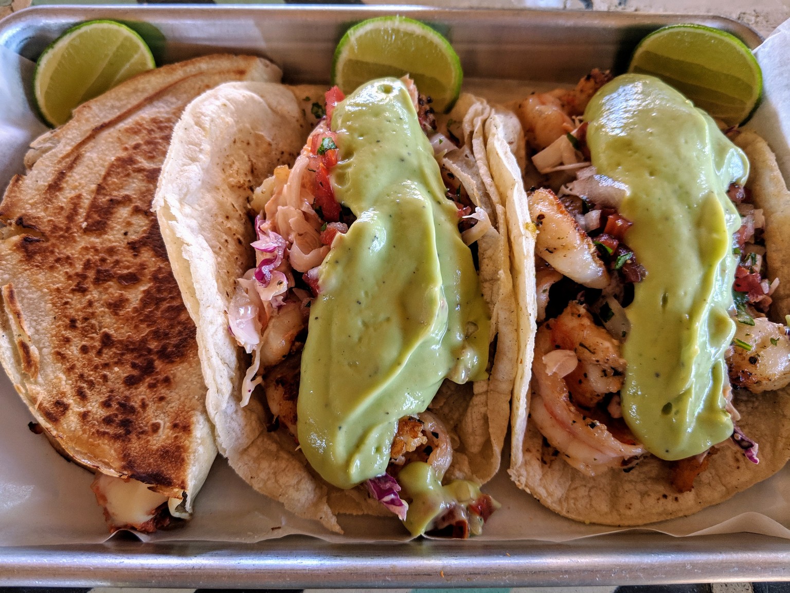 Shrimp tacos with creamy guacamole and a marlin quesadilla.