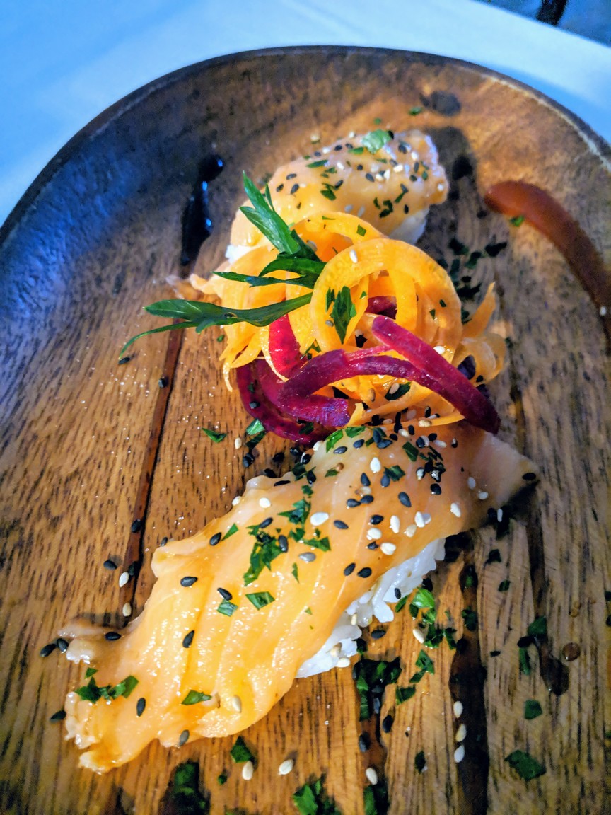 Salmon nigiri sushi. A little over embellished, but still good.
