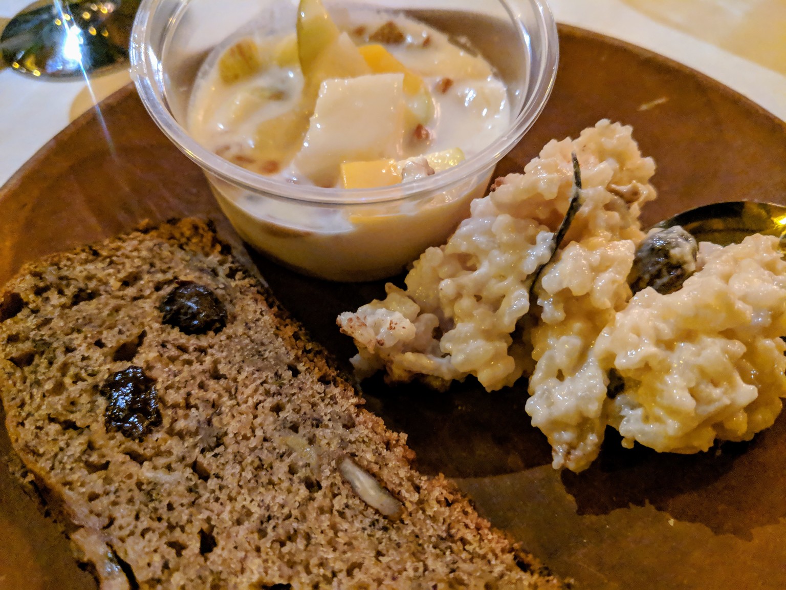 Christmas dessert, banana bread with raisins and walnuts, rice pudding and fruit with yogurt.
