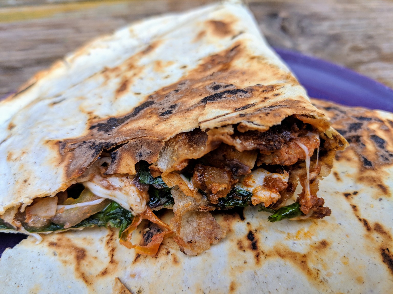 Tlayudas. Looks like a quesadilla, but it's got back beans as well as cheese, meat and veggies. Also, they are usually served open face instead of folded in half.