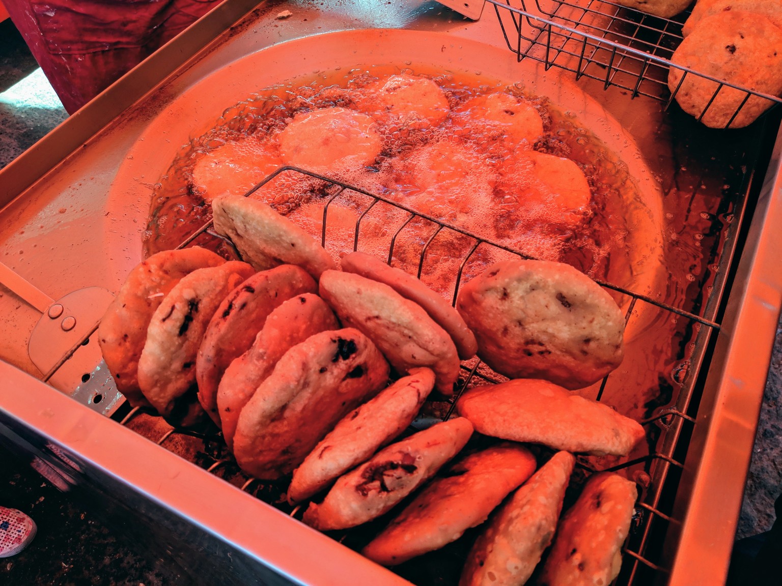 Frying gorditas. The light is bad because the place is under an orange tarp!