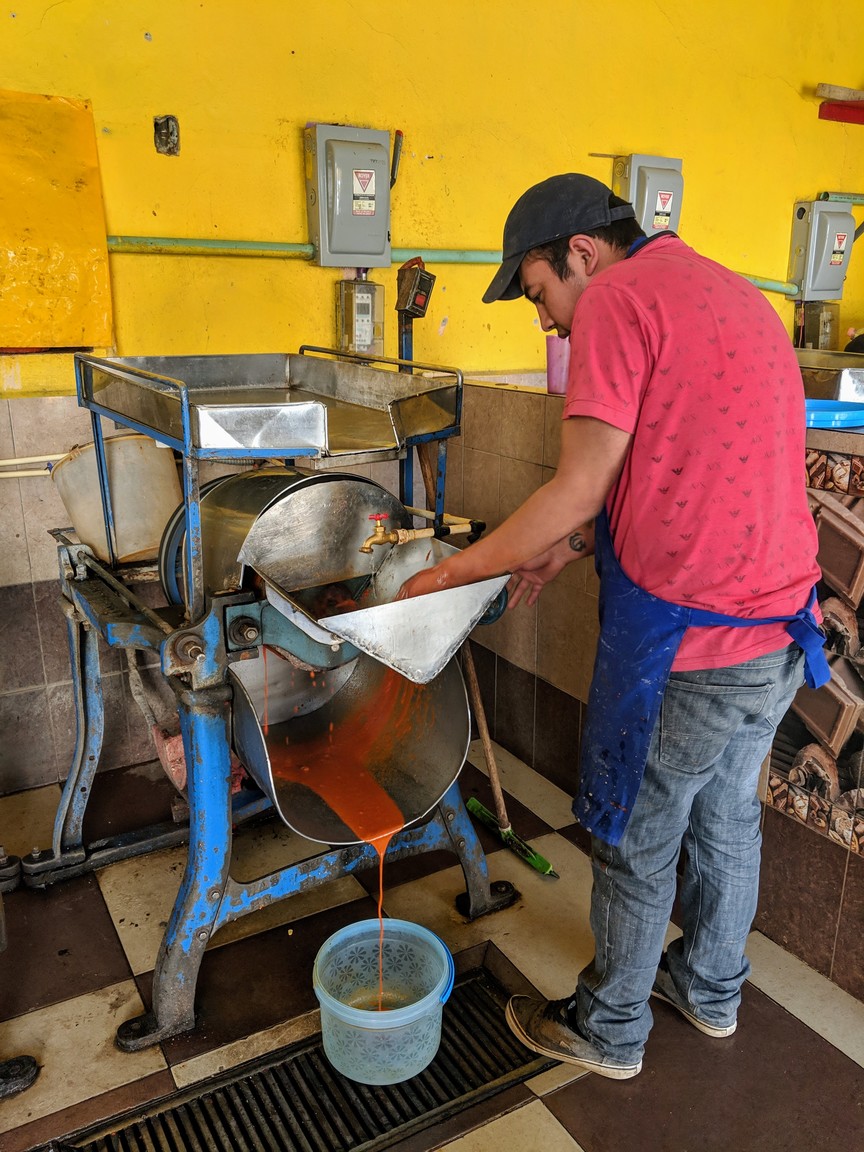 Grinding our mole at the local molina. For a small fee, they will grind your coffee, cacao, grains, or in our case, mole.