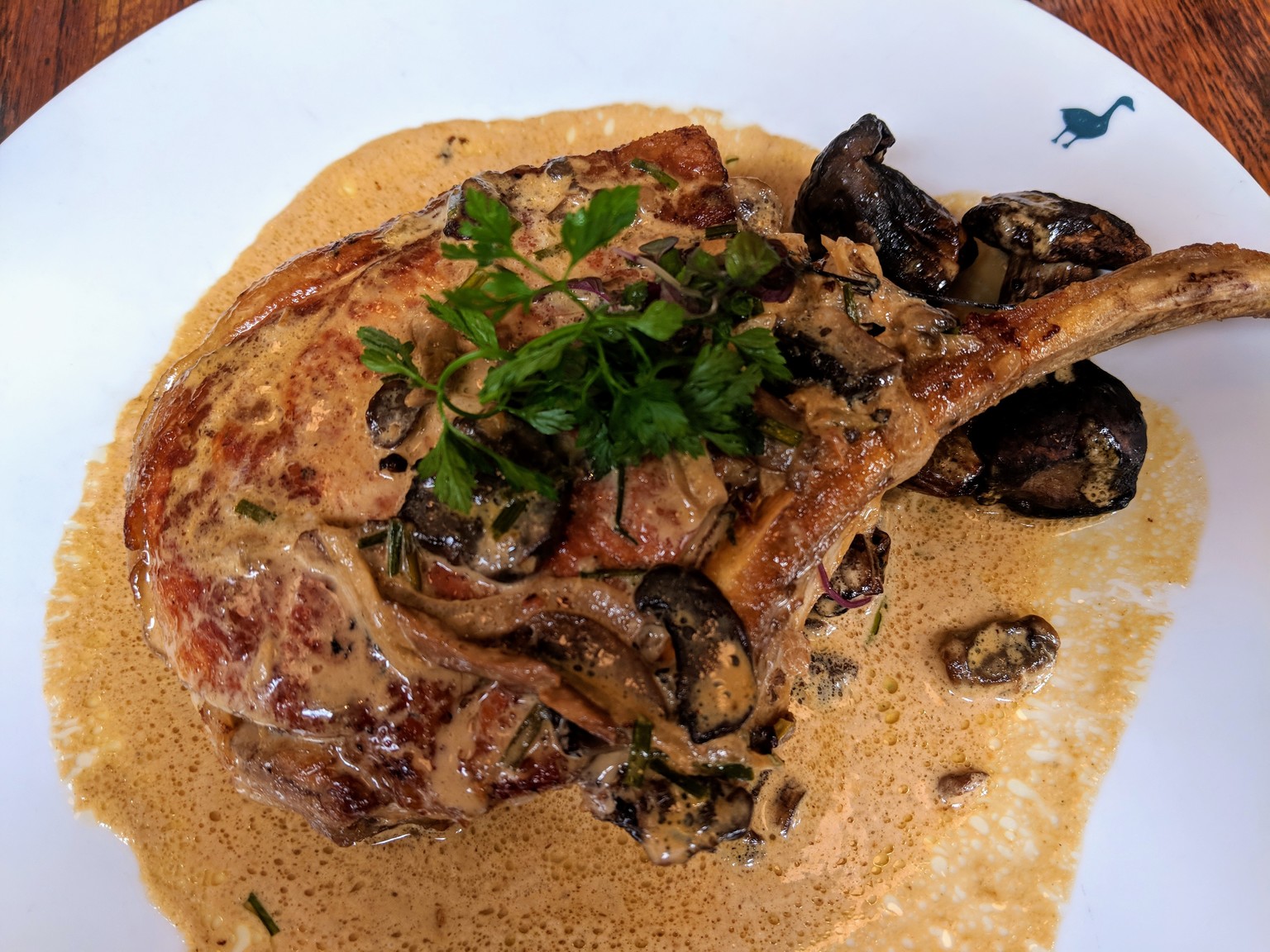 Best pork chop ever! Mushrooms and white wine sauce.