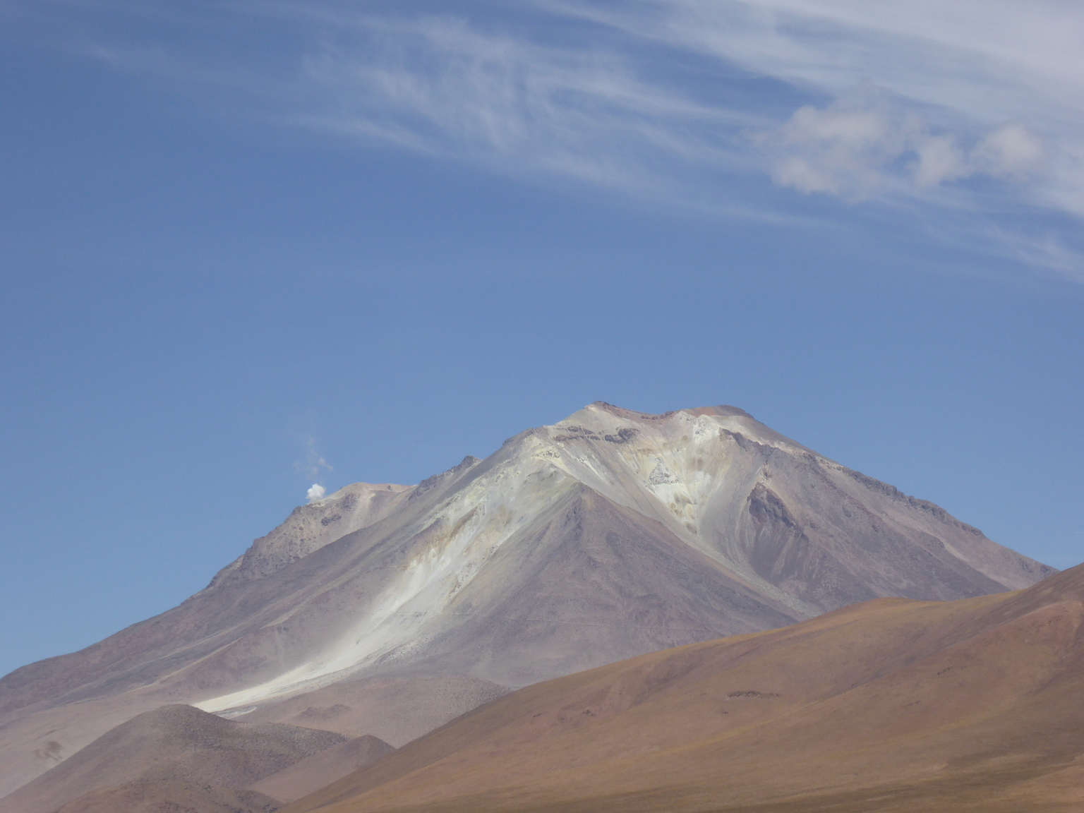 That's an active volcano, see the little puff of vapor on the left?